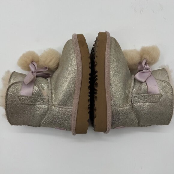 UGG Infant Girls Metallic Gold Sheepskin Bow Booties With Pom-Poms - Picture 7 of 11